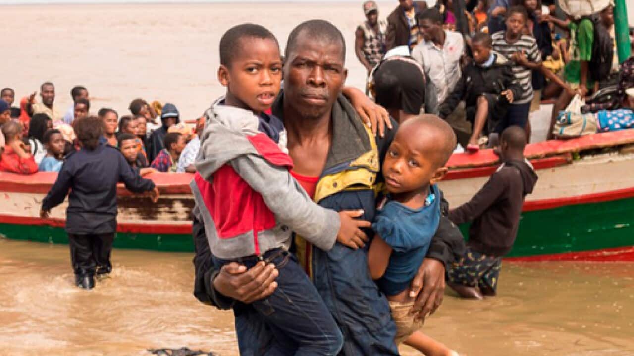 Survivors of Cyclone Idai arrive by rescue boat in Beira, Mozambique