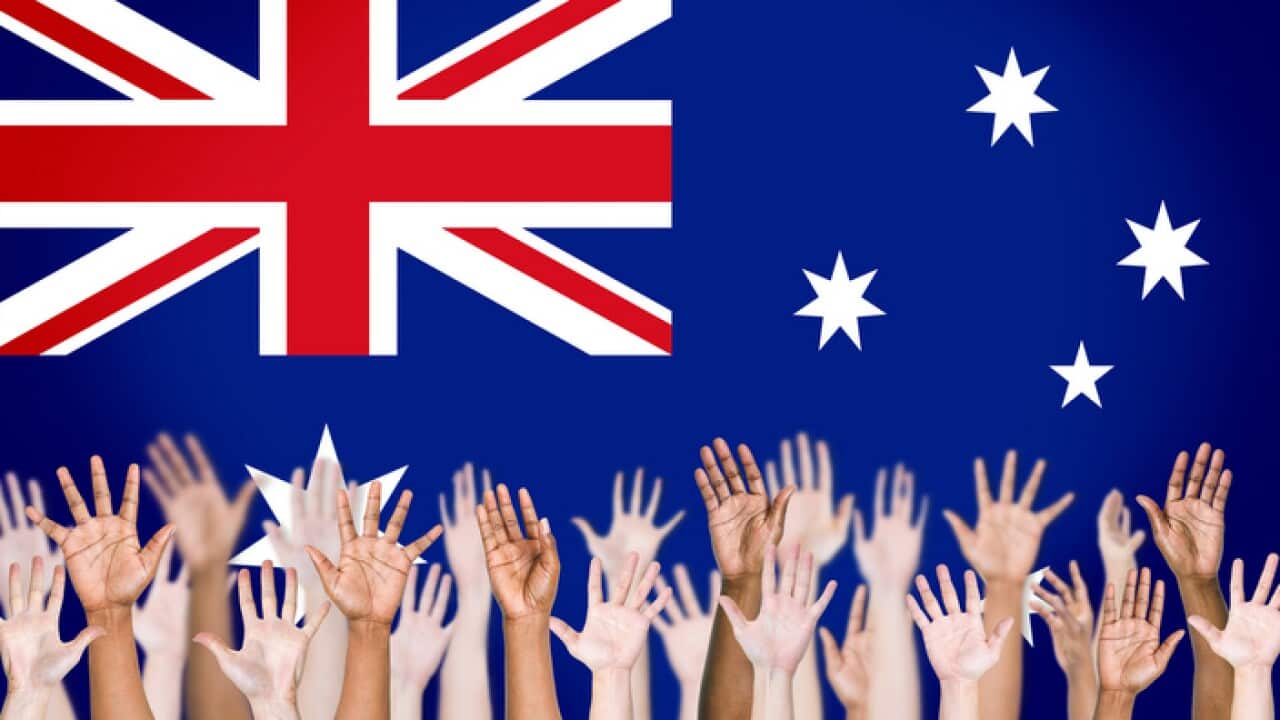 Multiethnic Arms Raised and Australian Flag Background