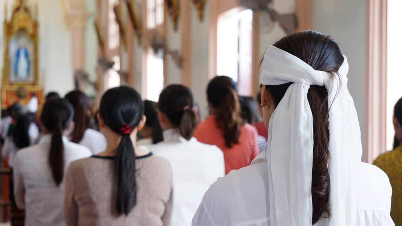 A woman in mourning, attends a Sunday Mass at a church in Yen Thanh district, Vietnam