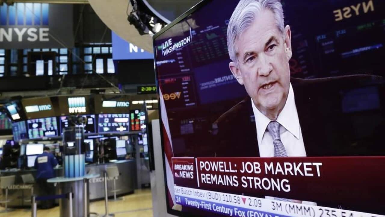 US Federal Reserve Chairman Jerome Powell on a television screen.
