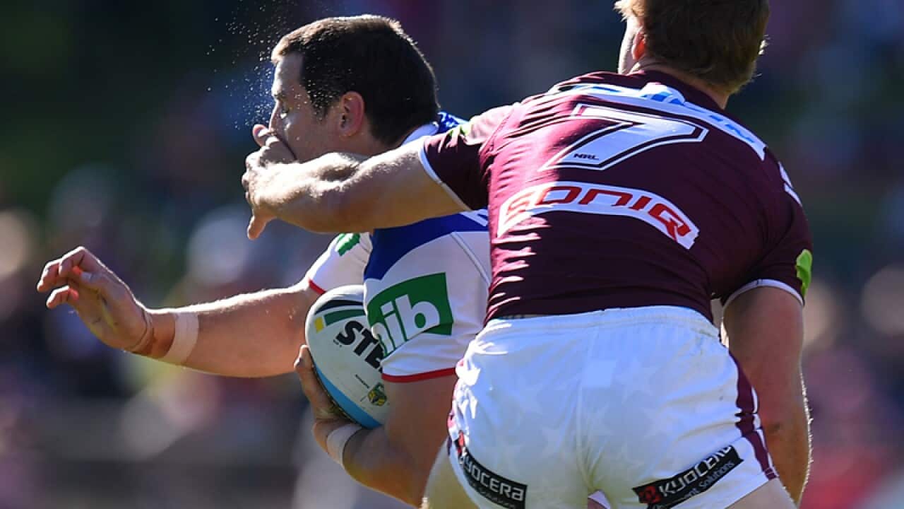 James McManus of the Newcastle Knights takes a high hit