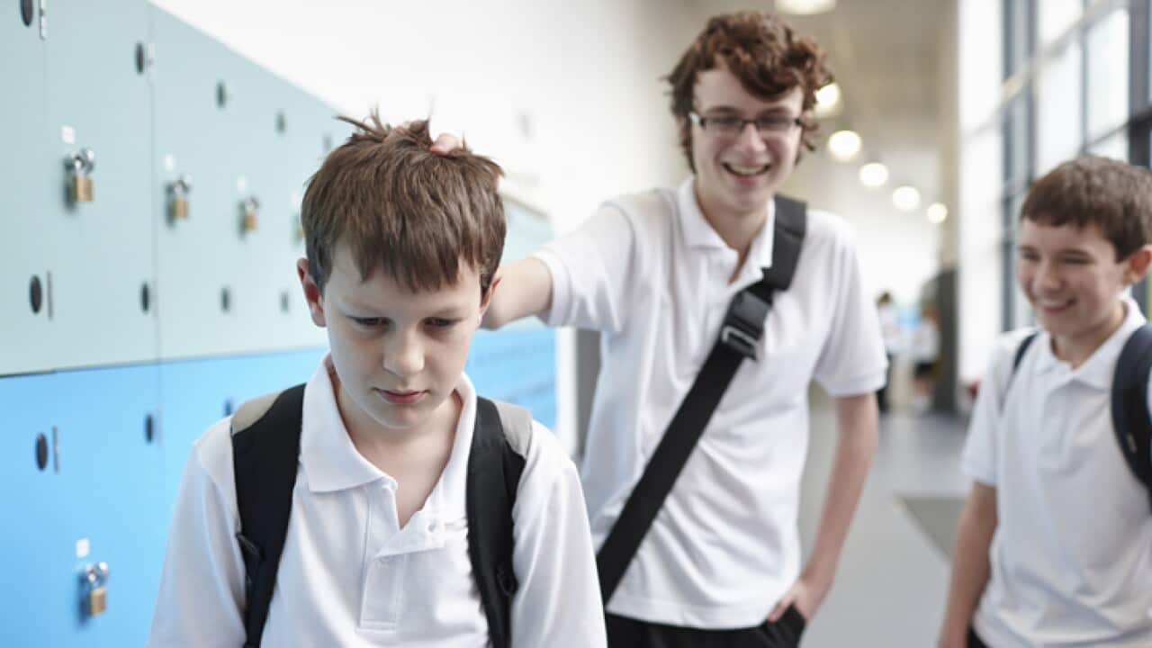 Schoolboy being bullied in school corridor