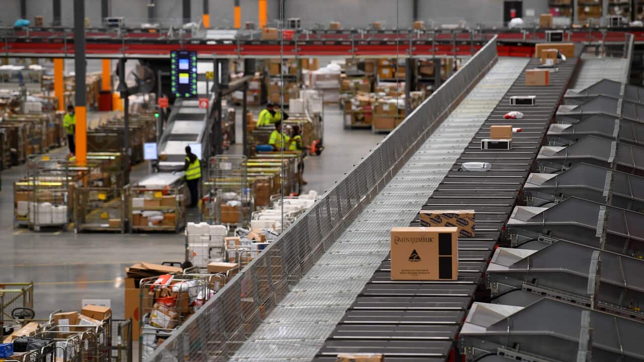 Parcels are seen on a production line at an Australia Post facility.