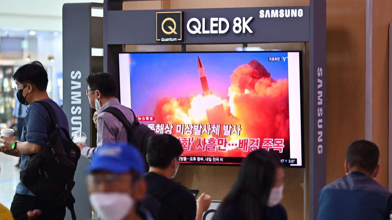 People watch a television news broadcast showing file footage of a North Korean missile test, at a railway station in Seoul on September 28, 2021.