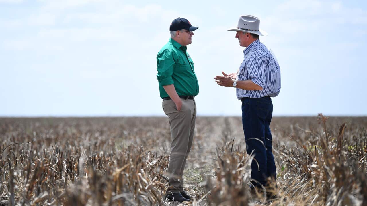 Australian Prime Minister Scott Morrison (left) chats to farmer David Gooding on his drought-affected property near Dalby, Queensland, Friday, September 2019.