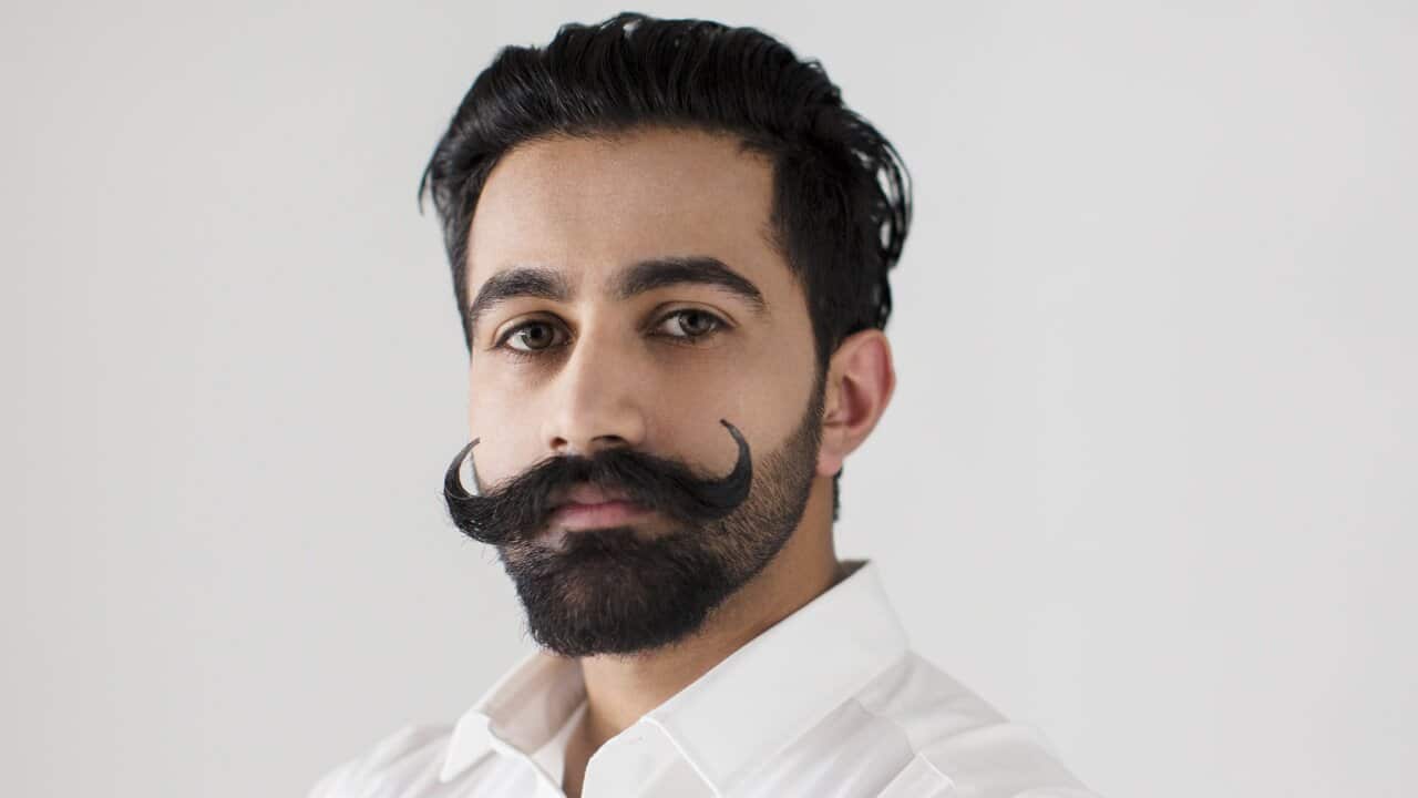 Portrait confident, serious young man with handlebar mustache