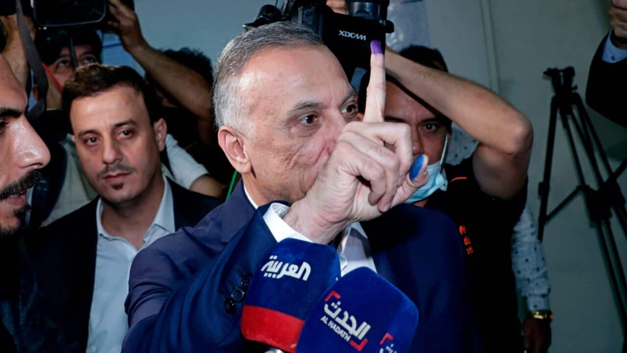 Iraqi Prime Minister Mustafa al-Kadhimi displays his ink-stained finger at a polling centre during the parliamentary elections in Baghdad, Iraq.