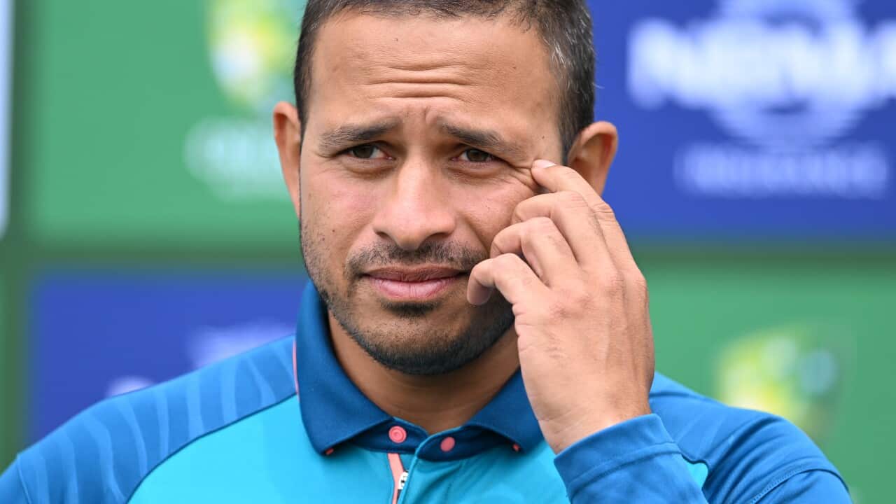 A man standing in front of microphones.