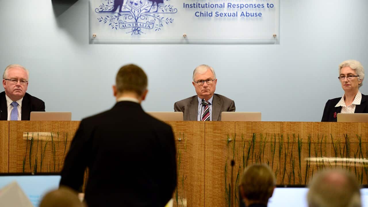 Members of the Royal Commission address a public hearing