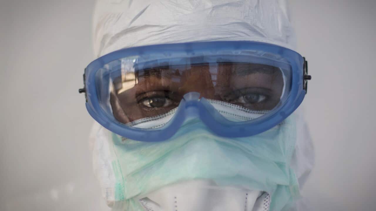 A health care worker wearing protective clothing