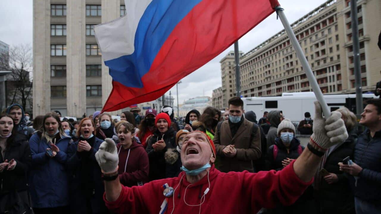 An activist with a Russian flag shouts slogan during an unsanctioned protest rally in support of jailed opposition leader Alexey Navalny at Manezhnaya Square in front of Moscow's Kremlin.
