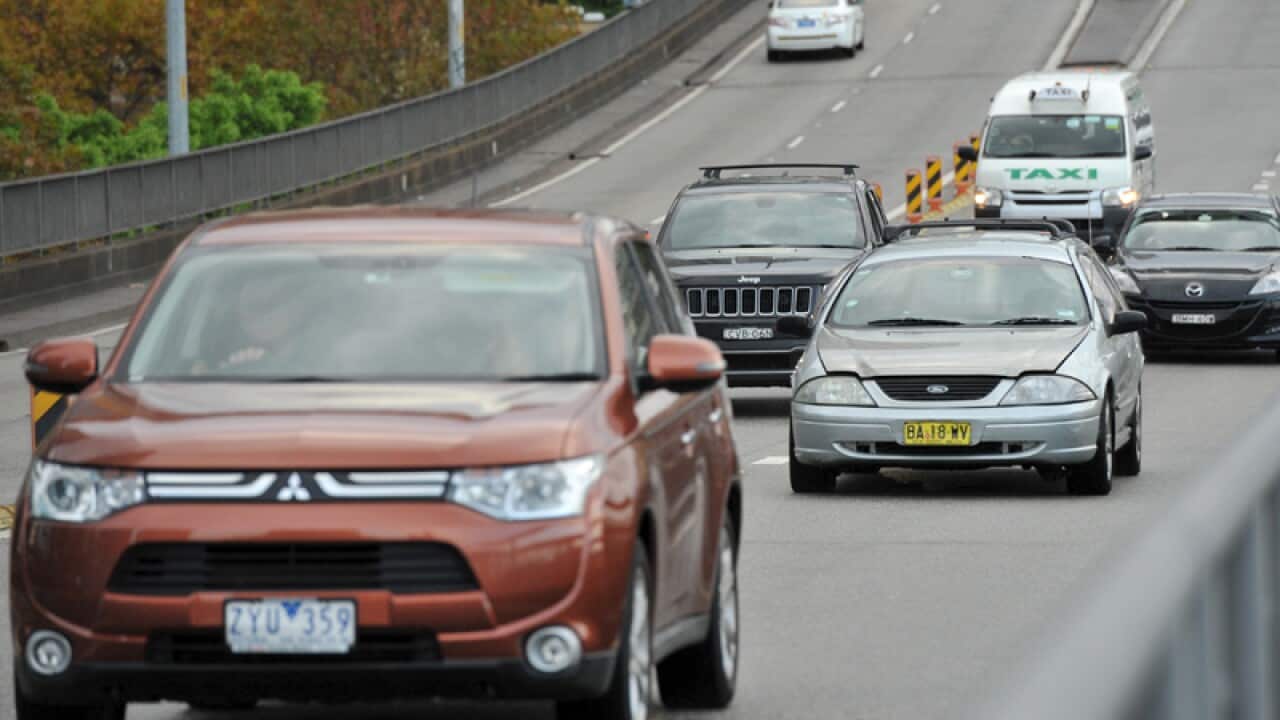 Cars travel along a motorway in Sydney