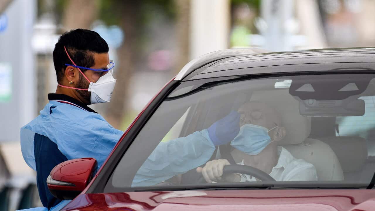 Healthcare workers administer COVID-19 tests at the St Vincent’s Hospital drive-through clinic in Sydney