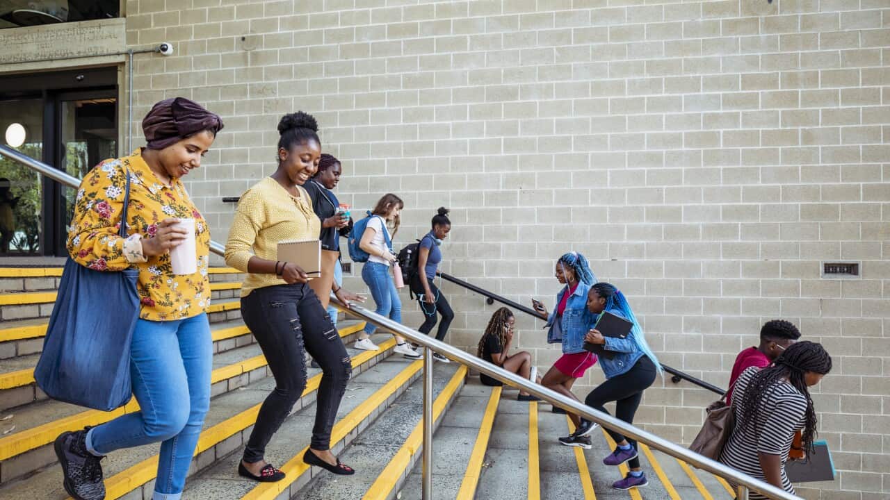 Students going in both directions up and down stairs.