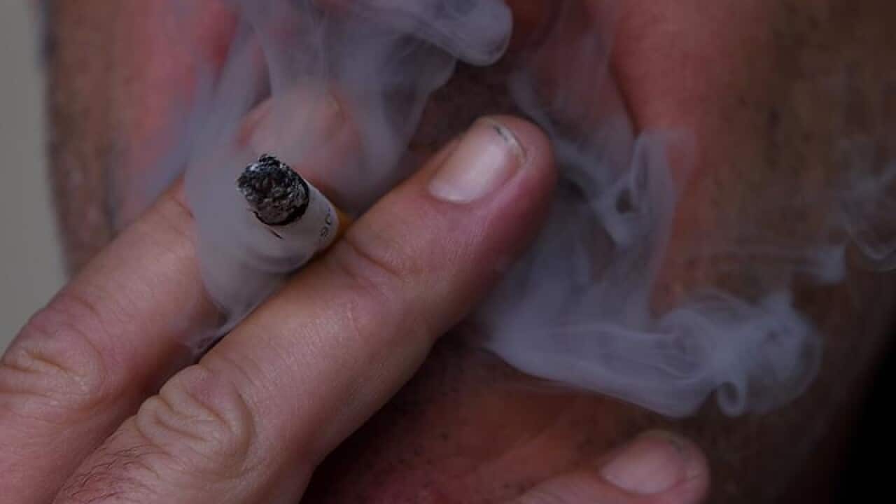 This is a file stock image of a man smoking a cigarette.