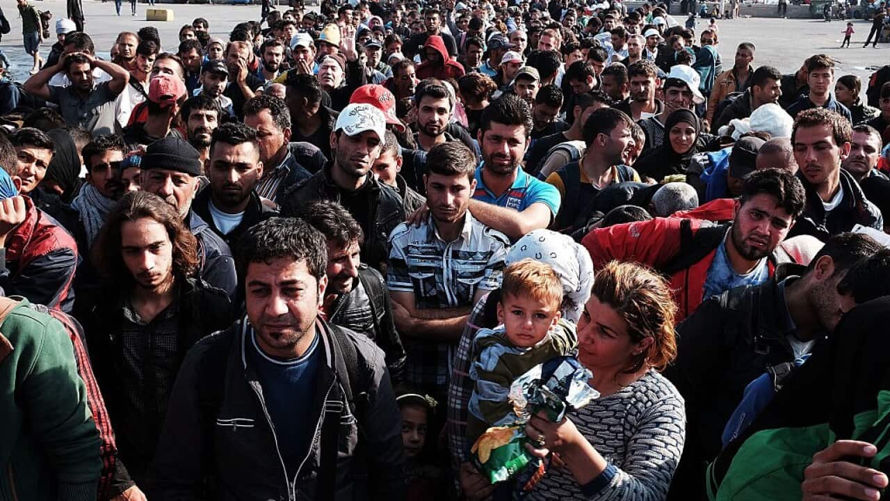Hundreds of recently arrived migrants wait to board a ferry to Athens on October 16, 2015 in Mytilene, Greece.