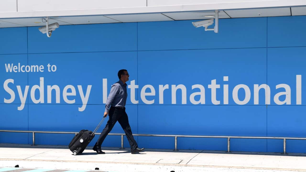 A passenger arrives at Sydney International Airport.