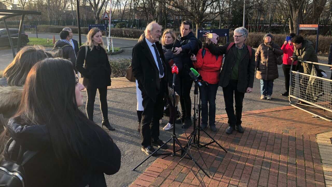 Julian Assange's father John Shipton talks to reporters outside the court