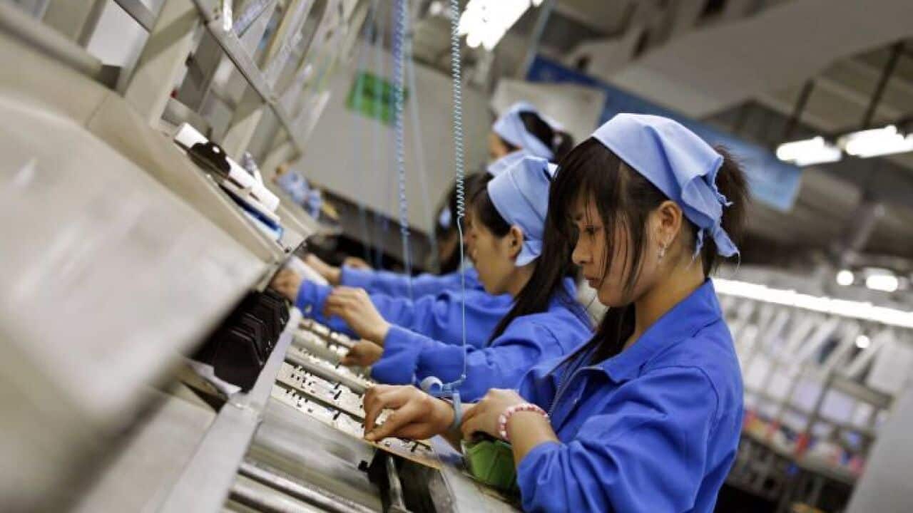 Chinese factory workers assemble electronics