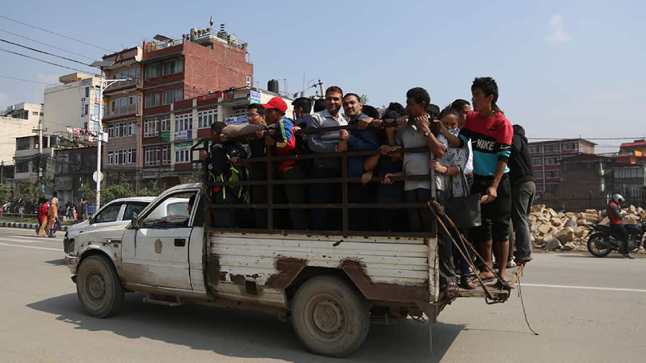 Nepalis take a ride in a pickup after public transport was shut down due to strike by service providers