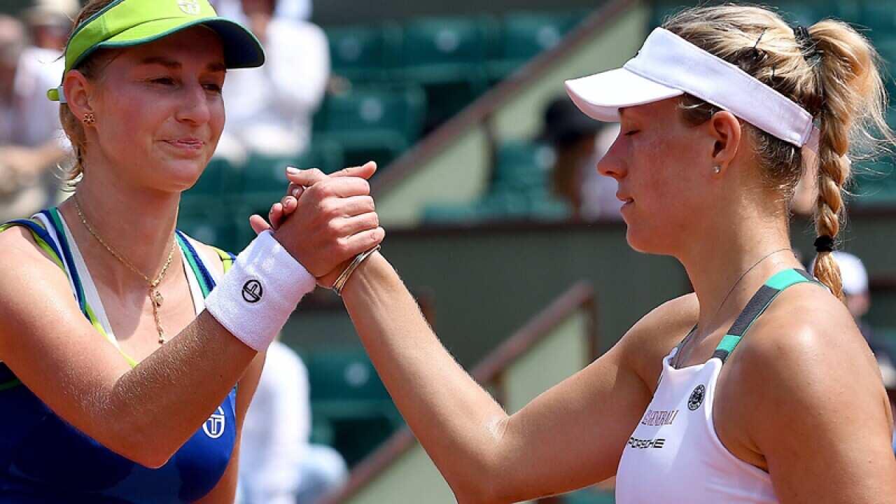 Tennis players Ekaterina Makarova and Angelique Kerbe shake hands