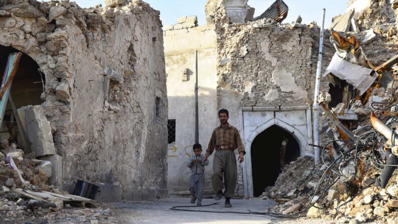A father and son in the ruins of Mosul