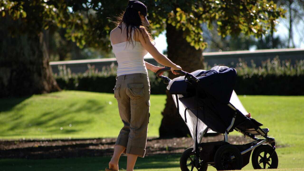 Mother pushing baby pram