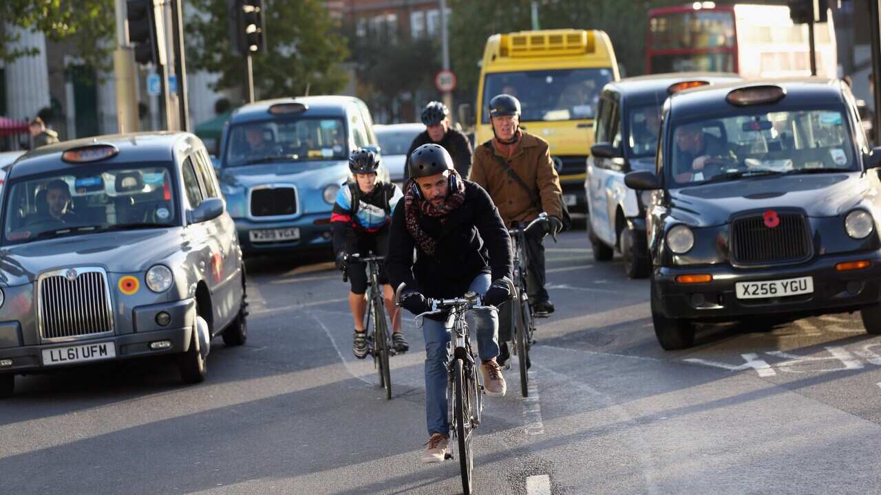 Cyclists negotiate rush hour traffic (Getty Image).