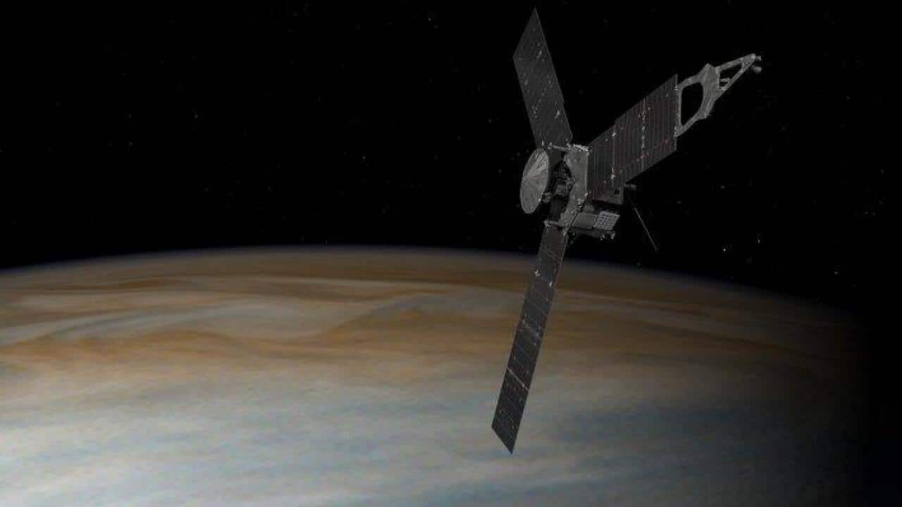 Illustration depicts NASA's Juno spacecraft in orbit above Jupiter