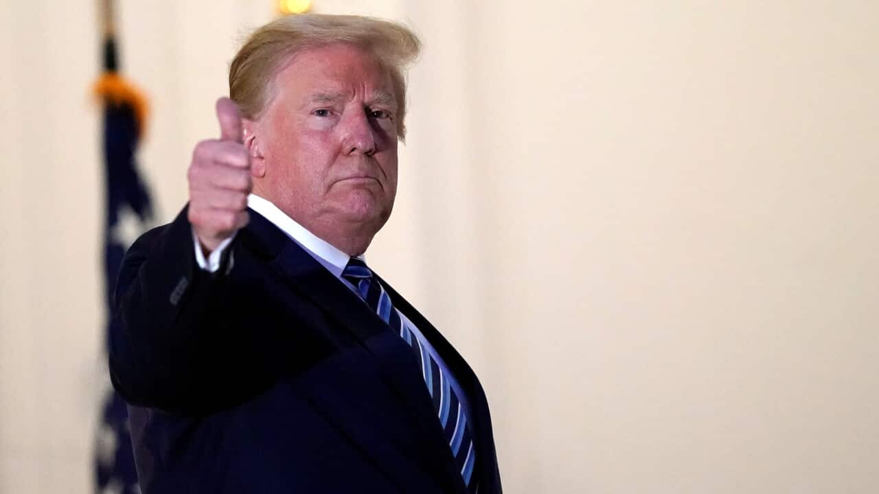 President Donald Trump gestures as he returns to the White House, after leaving Walter Reed National Military Medical Center