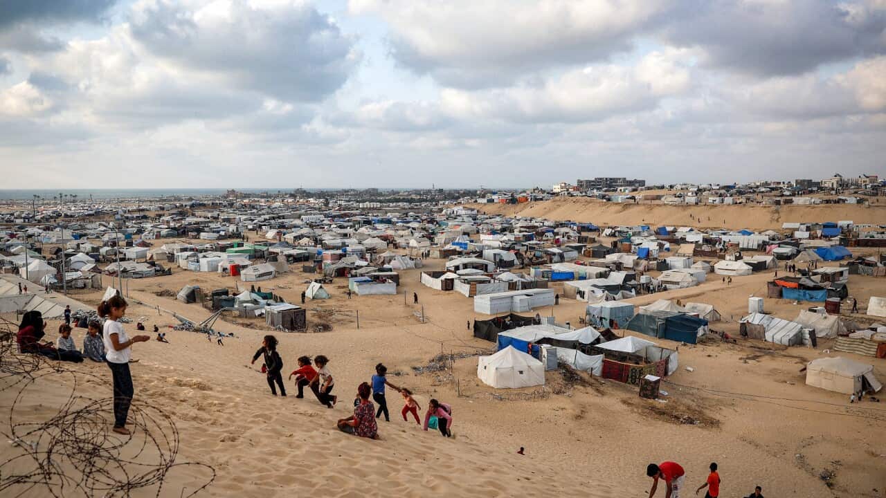 Children play along a slope near a camp housing displaced Palestinians in Rafah in the southern Gaza Strip (AAP)