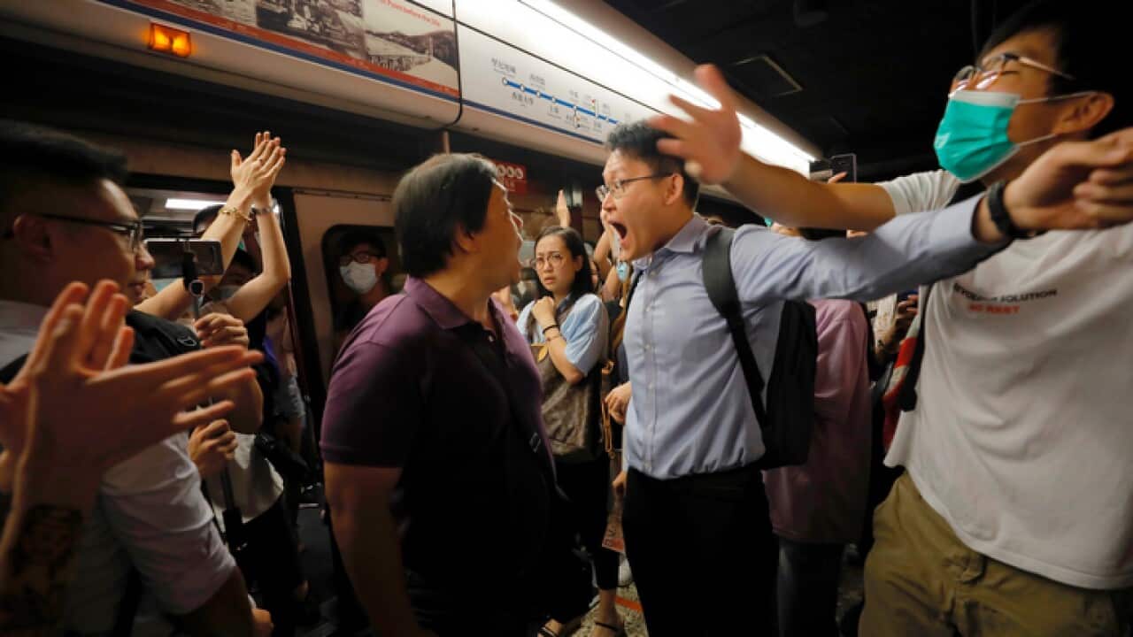 Passengers and protesters argue after a protest disrupted a subway line in Hong Kong.