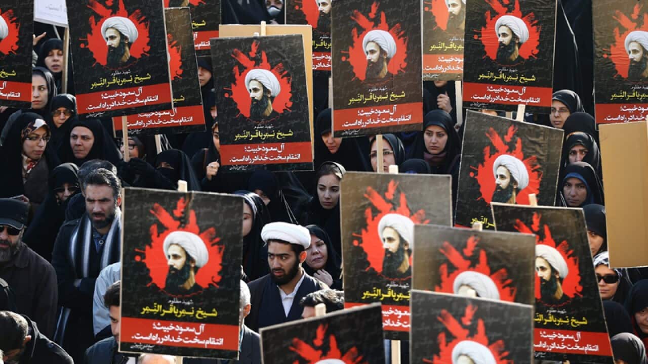Iranians hold posters of Shiite cleric Nimr al-Nimr