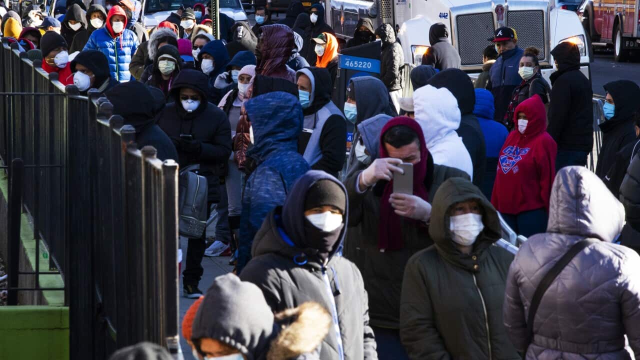 People line up outside Elmhurst Hospital to get tested due to coronavirus outbreak on 24 March, 2020 in Queens, New York City.
