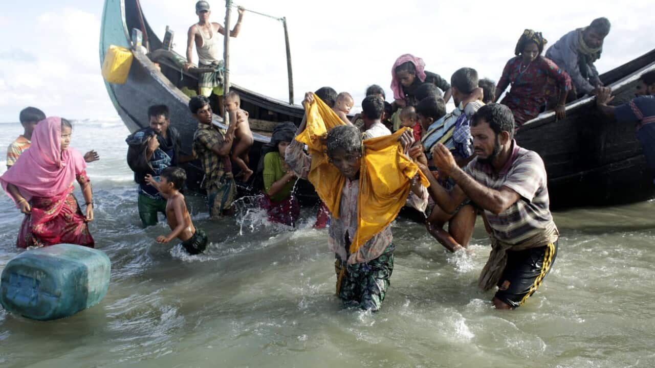 Rohingya Refugees walk towards the shore of Naf river as people arrive by boats, in Teknaf, Bangladesh