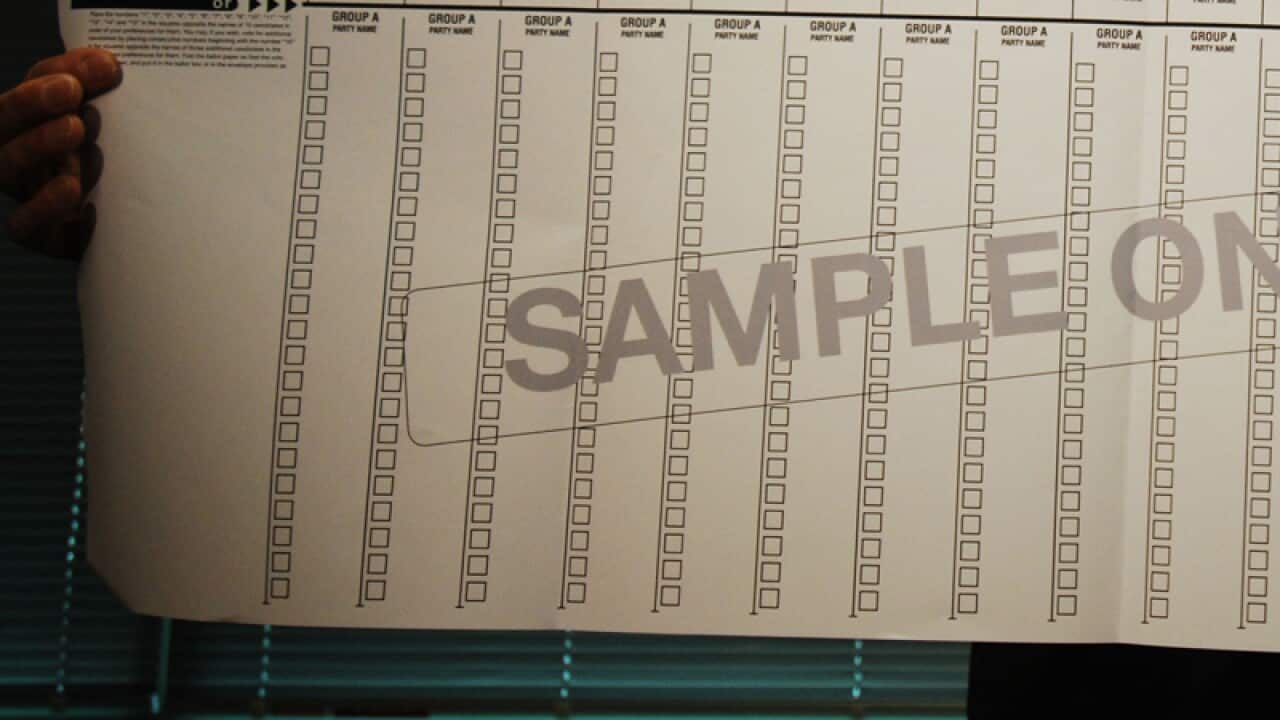 Electoral Commissioner Colin Barry shows a sample of the ballot paper