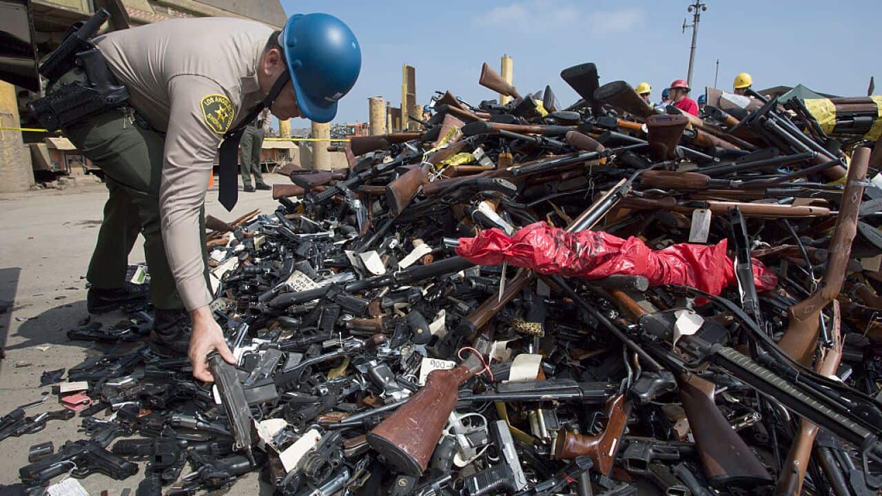 A Los Angeles County Sheriffs deputy looks at guns during the destruction of approximately 3,400 guns and other weapons at the Los Angeles County Sheriffs' 22nd annual gun melt on July 6, 2015