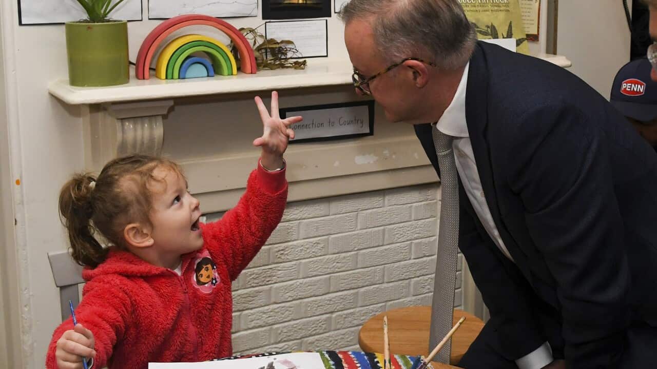 Australian Opposition Leader Anthony Albanese speaks to a child during a visit to a Goodstart Early Learning Childcare Centre on Day 39 of the 2022 federal election campaign in Sydney, Thursday, May 19, 2022. (AAP Image/Lukas Coch) NO ARCHIVING