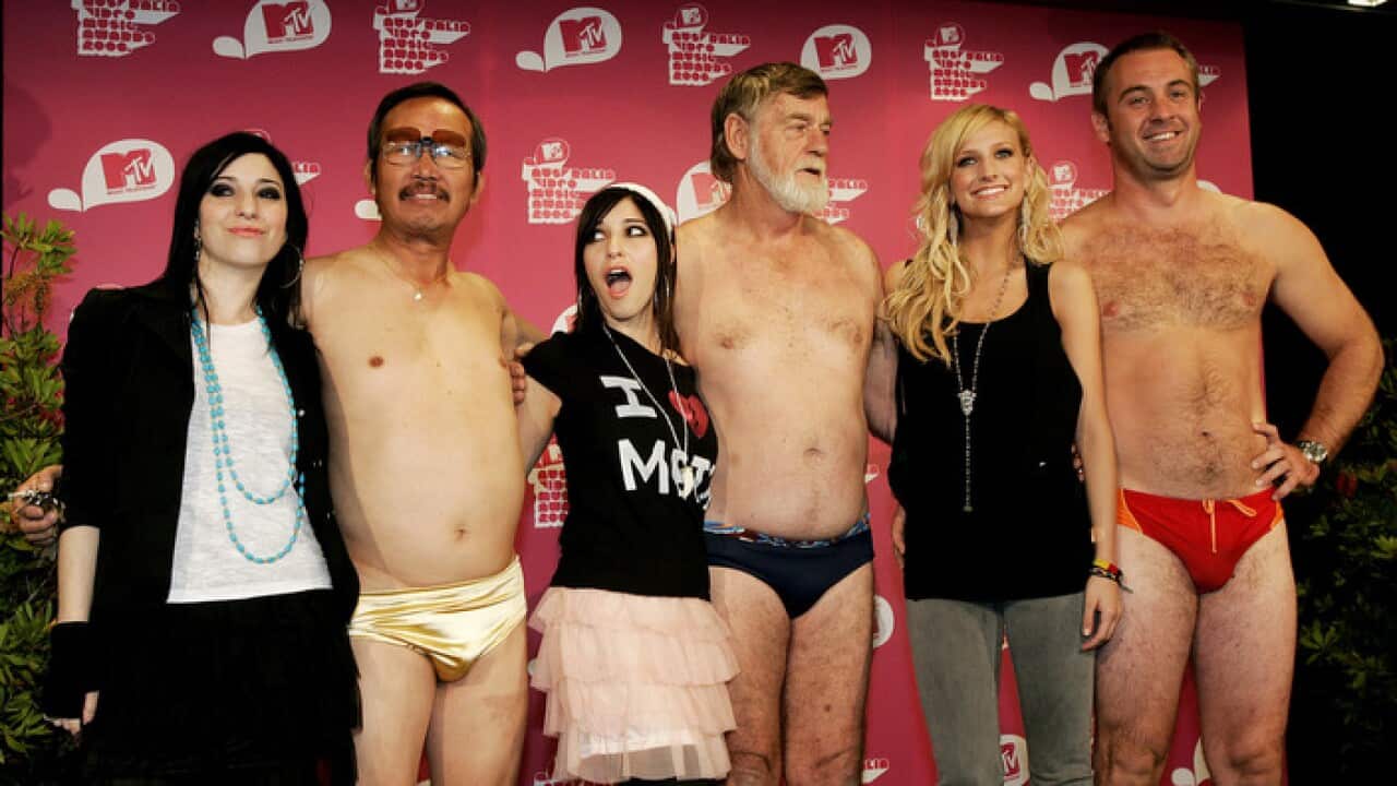 American singer Ashlee Simpson (right) and Australian singers The Veronicas (left) with men in budgie smugglers at the MTV Music Awards press conference in Sydney, Tuesday, April 11, 2006. Simpson will be hosting the The MTV Music Awards which are held a