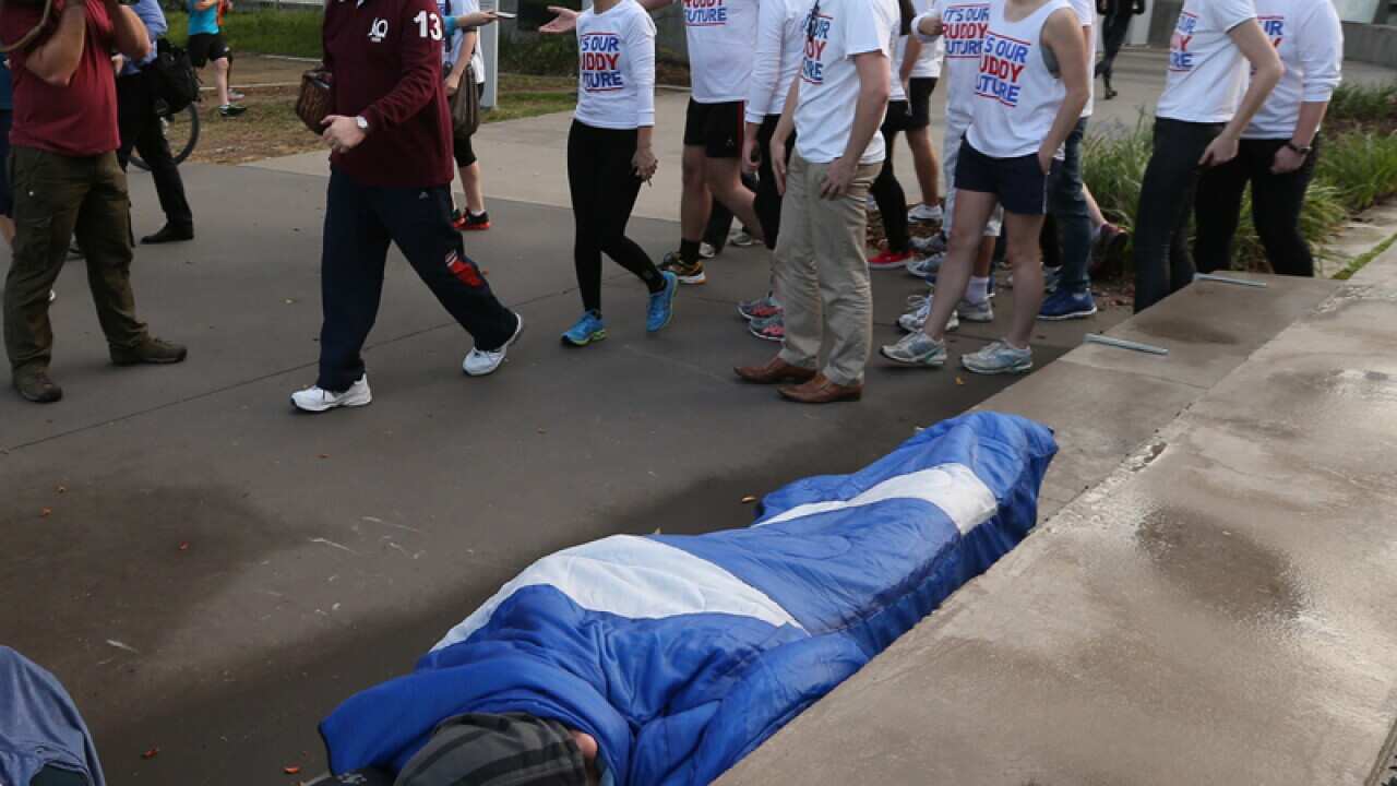 Kevin Rudd walking past a homeless man in Brisbane