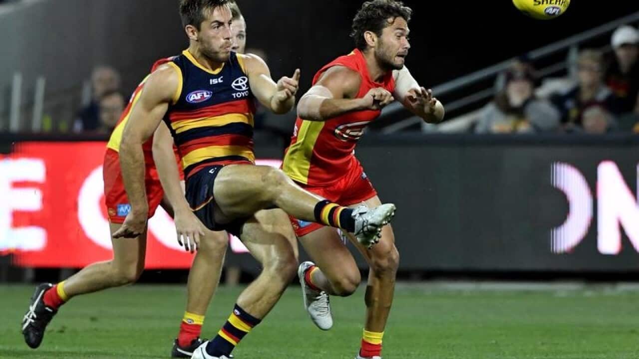 Crows Richard Douglas kicks a goal.