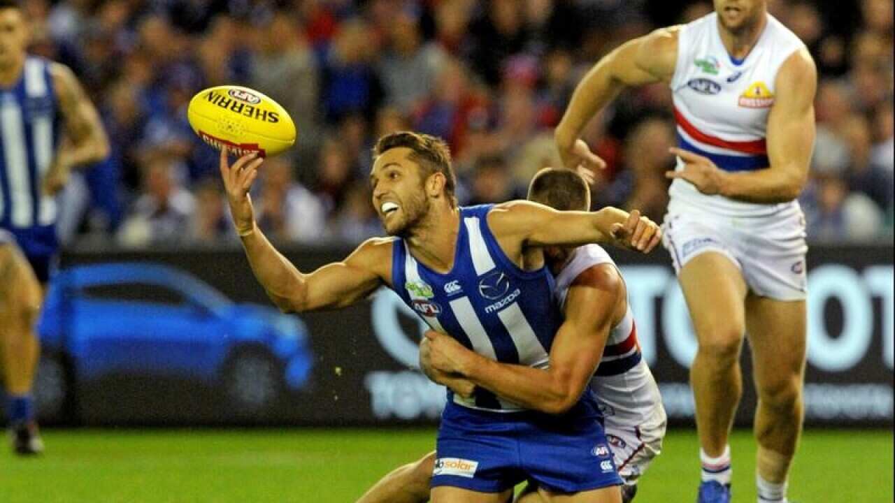 Jamie Macmillan of the Kangaroos attempts to take a mark.