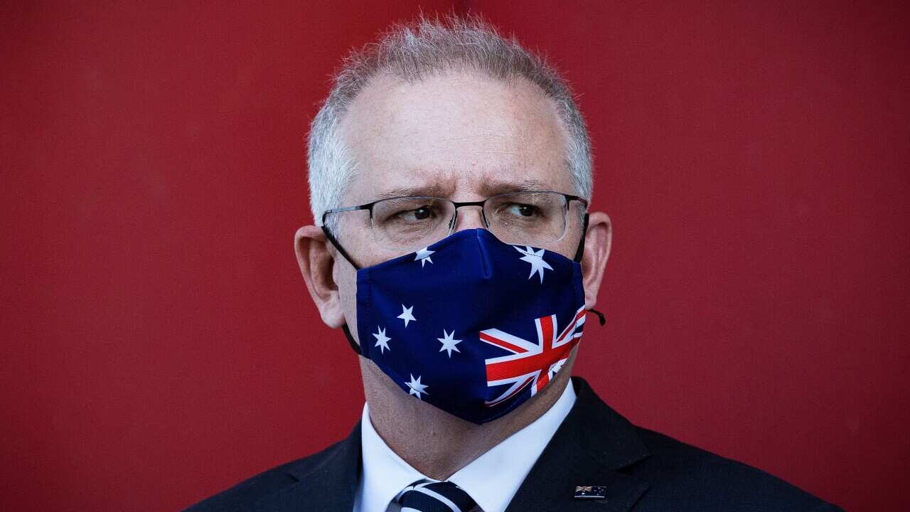 Prime Minister Scott Morrison wearing a patriotic mask at a press conference last week where a COVID-19 vaccine is being produced.
