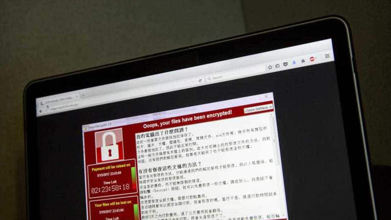 a screenshot of the warning screen from a purported ransomware attack, as captured by a computer user in Taiwan, is seen on laptop in Beijing.