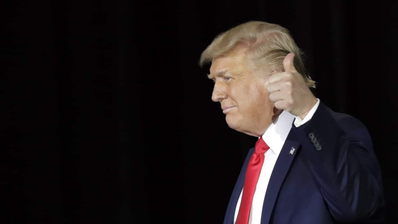 President Donald Trump gives a thumbs up.