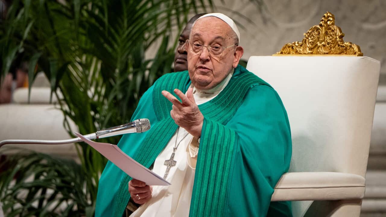 Pope Francis wearing white and green robes