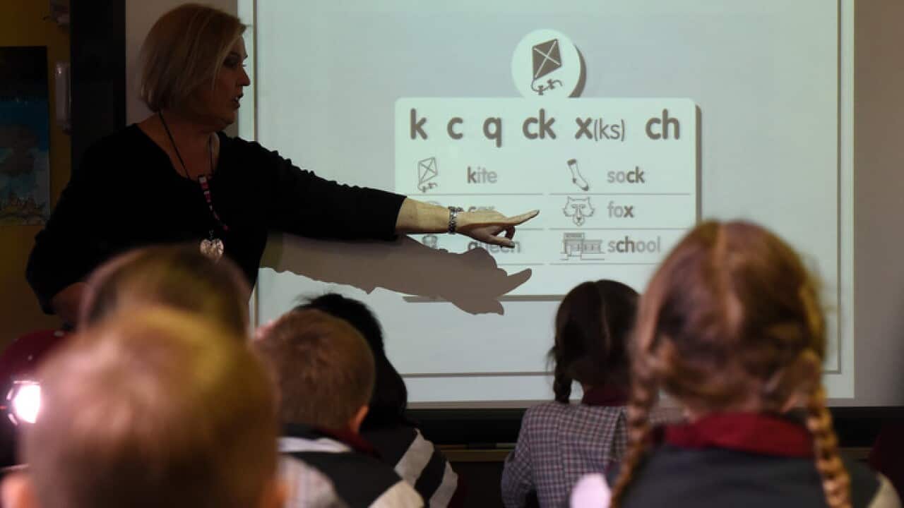 A teacher points at a board during a lesson at Stafford State School in Brisbane, Wednesday, Aug. 5, 2015. Queensland Premier Annastacia Palaszczuk has applauded the state's school students, saying their NAPLAN improvements are the best in the country.