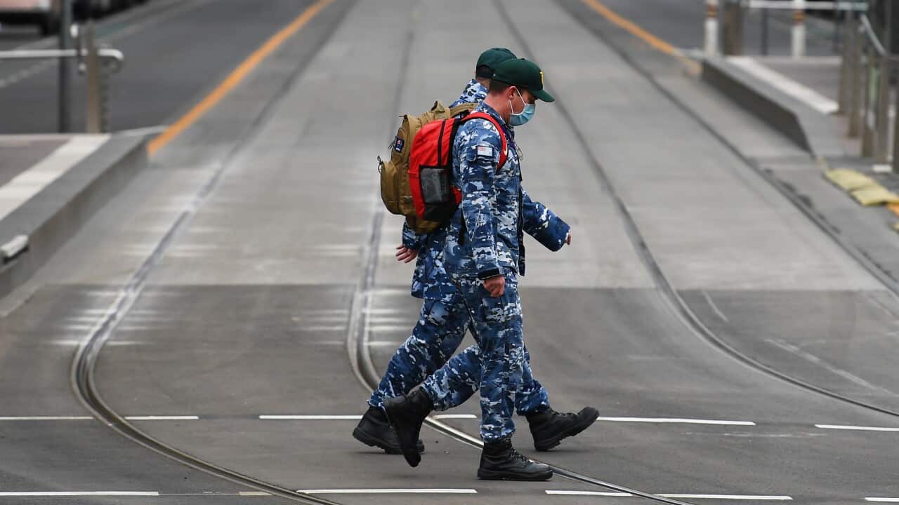 Royal Australian Air Force personnel patrol through the empty streets of Melbourne's CBD.