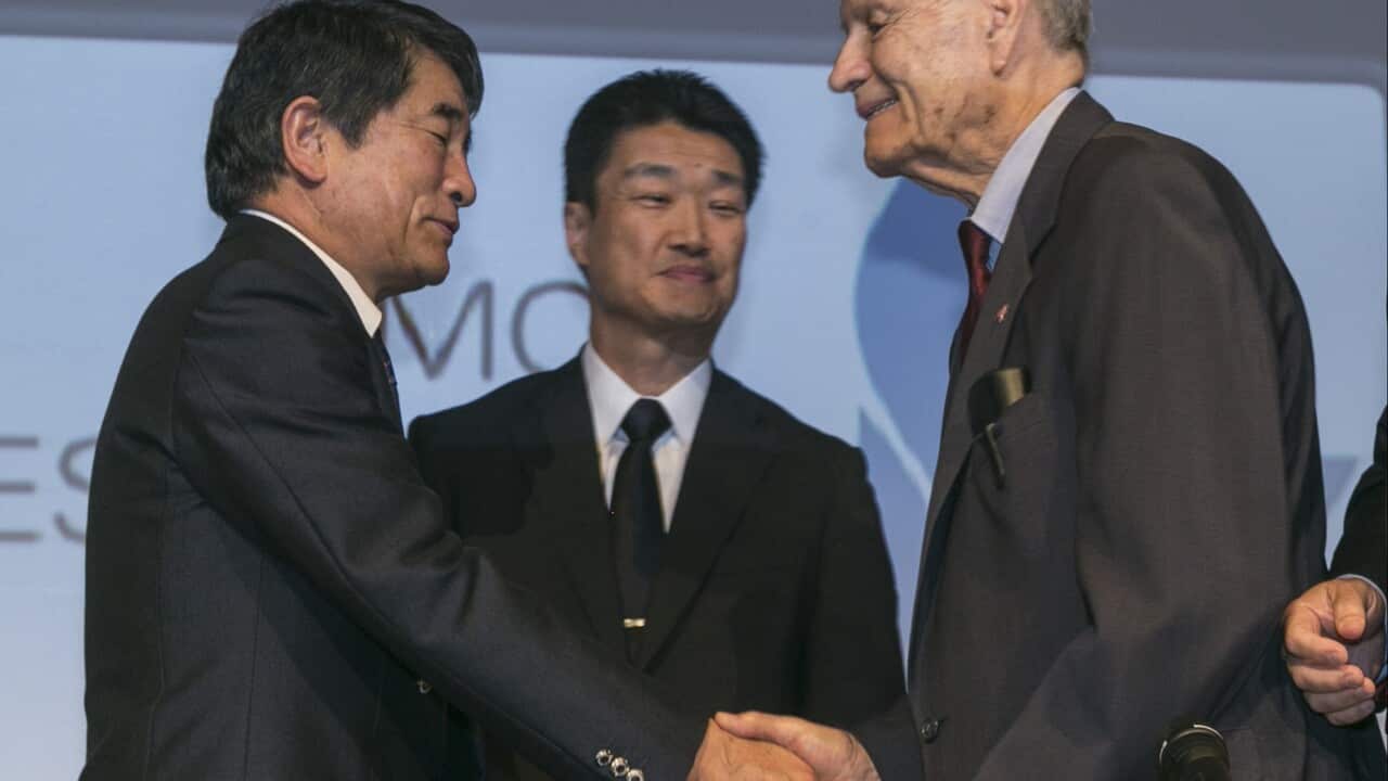Yukio Okamoto and Hikaru Kimura offer an apology as they hold hands with 94-year-old U.S. prisoner of war, James Murphy.