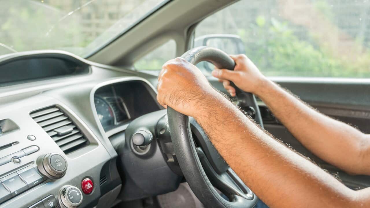 Hands male driving in his car.